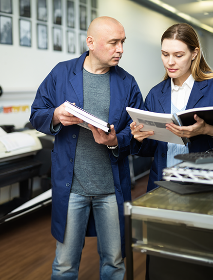 Two print operators reviewing project together