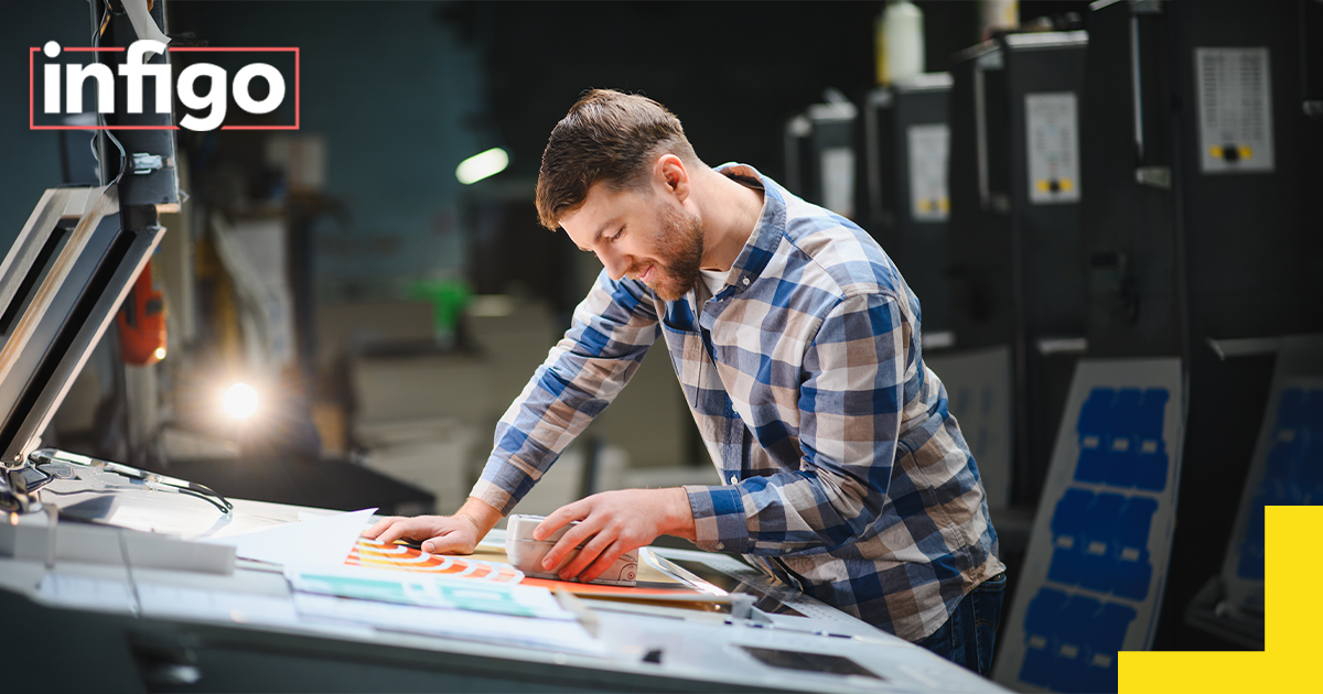 Print operator evaluating color swatches and samples, ensuring print quality