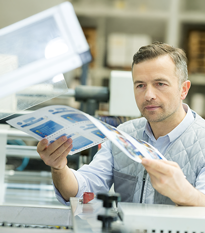 Man taking printed material out of printer