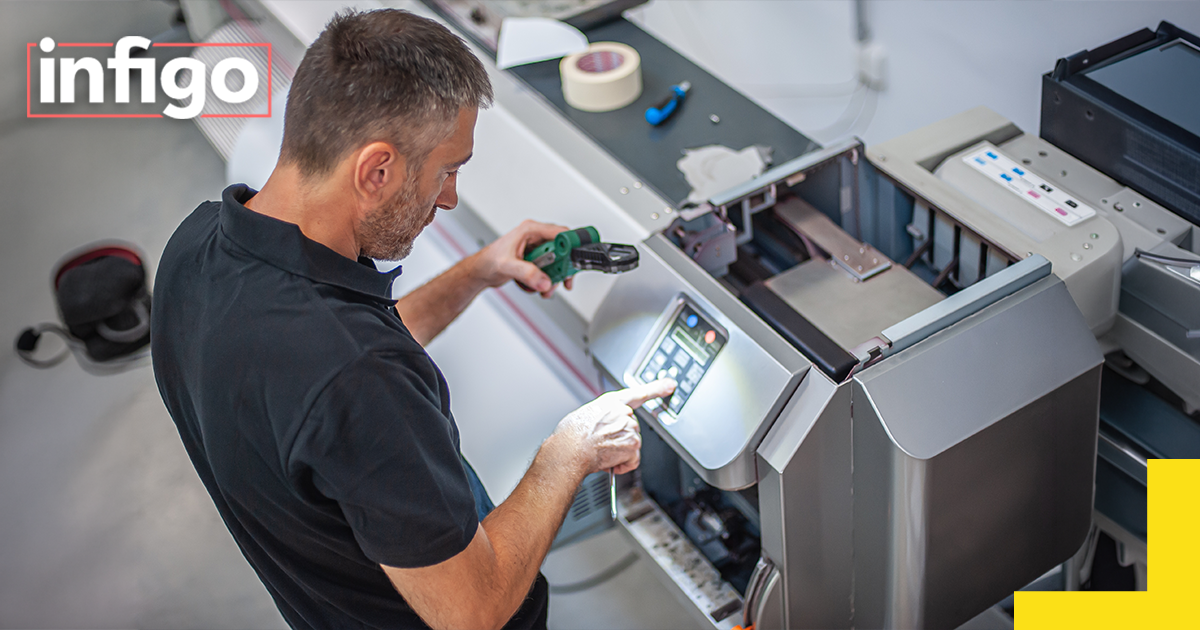 Man operating industrial printer